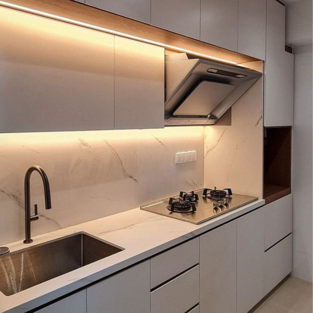 Under-Cabinet Lighting of a kitchen cabinet with a sink, and a oven and a chimney
