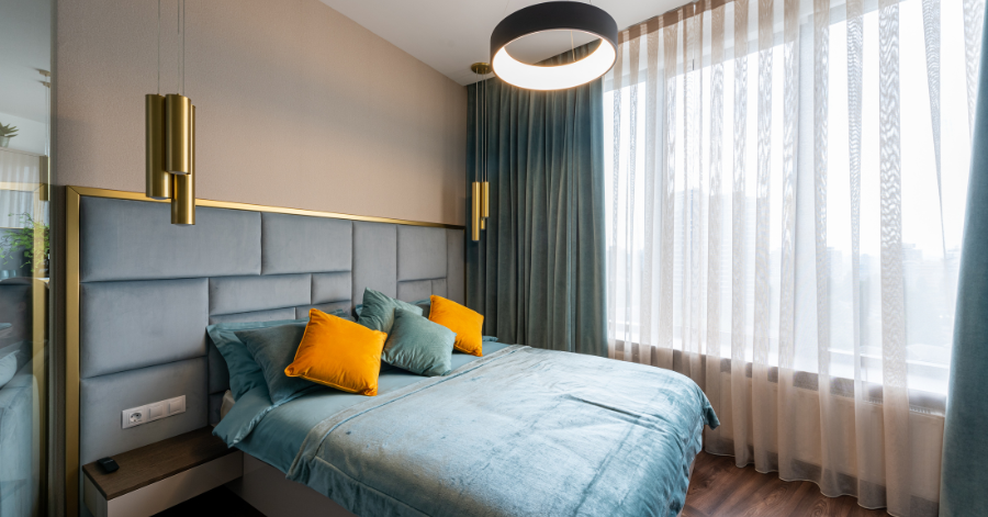 Modern 2Bhk bedroom with a quuen size bed, customized bed head, ceiling pendent transparent curtain